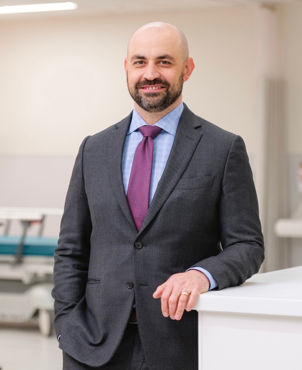 Portrait of Dr. Brandon Hirsch, MD, wearing a suit